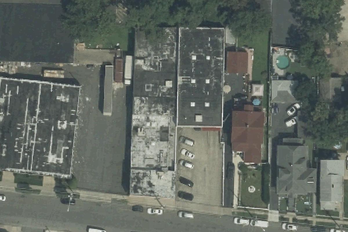 2023 USDA NAIP overhead of 134-138 Kansas Street, showing the full subject building roof and parking/access context; historical aerial, listing extent unverified.